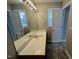 Well-lit bathroom featuring a large mirror, vanity, and tiled flooring at 247 Anna St, Lillington, NC 27546