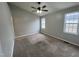 Comfortable bedroom with carpeted floors, neutral walls and natural lighting at 247 Anna St, Lillington, NC 27546