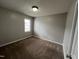 Cozy bedroom featuring neutral walls, carpeted floor, and natural light from the window at 247 Anna St, Lillington, NC 27546