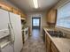 Functional kitchen with light wood cabinetry and standard white appliances at 247 Anna St, Lillington, NC 27546