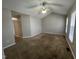 Open living room featuring a vaulted ceiling, fan, and carpeted floor at 247 Anna St, Lillington, NC 27546