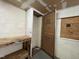 Image showcases a basement area with unfinished storage spaces and a workbench at 2904 Jefferson Davis Hwy, Sanford, NC 27332