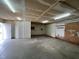 A look at the basement with concrete floors, utility features, and a large open doorway at 2904 Jefferson Davis Hwy, Sanford, NC 27332