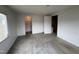 A bedroom featuring neutral walls, carpet, and natural light from the large window at 2904 Jefferson Davis Hwy, Sanford, NC 27332