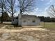 Cozy one-story home featuring a brick patio, neutral siding, and mature trees at 2904 Jefferson Davis Hwy, Sanford, NC 27332