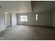 A spacious living room with a large window and neutral carpet at 2904 Jefferson Davis Hwy, Sanford, NC 27332