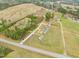 Expansive aerial view of the property, featuring large land parcels with mature trees and open areas at 30 Chaney Ln, Louisburg, NC 27549