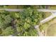 An aerial view of a home surrounded by lush trees with a road nearby at 313 Main St, Knightdale, NC 27545