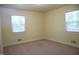 Bright and cozy bedroom featuring large windows and plush carpeting at 313 Main St, Knightdale, NC 27545