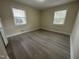 Bright bedroom with two windows and neutral paint, complemented by light wood-look flooring at 313 Main St, Knightdale, NC 27545