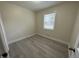 Cozy bedroom offering new flooring, neutral walls and natural light from the window at 313 Main St, Knightdale, NC 27545