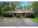 Charming duplex with a brick facade, complemented by a lush, tree-lined front yard at 313 Main St, Knightdale, NC 27545