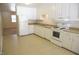 Functional kitchen with white cabinets, essential appliances, and ample counter space at 313 Main St, Knightdale, NC 27545