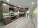 Modern kitchen featuring stainless steel appliances, granite countertops, and new flooring at 313 Main St, Knightdale, NC 27545
