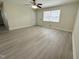 Bright living room featuring neutral walls, new flooring and natural light from a window at 313 Main St, Knightdale, NC 27545