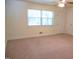 Inviting living room with plush carpeting, fan, and natural light at 313 Main St, Knightdale, NC 27545