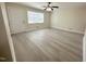 Inviting living room with a door to the outside, a ceiling fan and updated flooring at 313 Main St, Knightdale, NC 27545