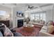 Bright living room with coffered ceiling, fireplace, and plush seating offers a cozy and stylish gathering space at 323 Augusta Pond Way # 171, Raleigh, NC 27603