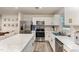 Bright kitchen features white cabinets, stainless appliances, and marble countertops at 329 Golden Plum Ln, Zebulon, NC 27597