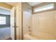 Bathroom showcasing a shower-tub combination and an open door to another room at 3316 Perkins Ridge Rd, Raleigh, NC 27610