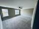 Spacious bedroom with neutral walls, plush carpet, and bright windows with outdoor views at 3316 Perkins Ridge Rd, Raleigh, NC 27610