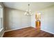 Open-concept dining area showcases wood floors and a stylish chandelier for elegant meals at 3316 Perkins Ridge Rd, Raleigh, NC 27610