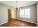 Inviting dining space featuring wood floors, a classic chandelier, and abundant natural light at 3316 Perkins Ridge Rd, Raleigh, NC 27610