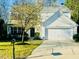 Charming two-story home with attached garage, landscaped yard and a fresh green lawn at 3316 Perkins Ridge Rd, Raleigh, NC 27610