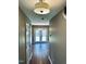 Inviting hallway with hardwood floors and neutral paint, leading to the back patio at 3316 Perkins Ridge Rd, Raleigh, NC 27610