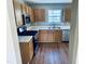 Well-lit kitchen with oak cabinets, white countertops, stainless steel appliances, and hardwood floors at 3316 Perkins Ridge Rd, Raleigh, NC 27610
