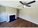 Cozy living room features hardwood floors, neutral walls, fireplace and a ceiling fan at 3316 Perkins Ridge Rd, Raleigh, NC 27610