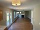 Bright living room with fireplace, modern lighting, and patio doors to the green yard at 3316 Perkins Ridge Rd, Raleigh, NC 27610