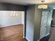 Open floor plan with hardwood floors leading into dining space with light fixtures at 3316 Perkins Ridge Rd, Raleigh, NC 27610