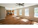Open-concept living room featuring hardwood floors, a ceiling fan, and access to the kitchen at 3316 Perkins Ridge Rd, Raleigh, NC 27610