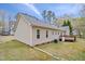 Backyard featuring a deck area, well-maintained lawn and tall mature trees at 340 Castleberry Rd, Clayton, NC 27527