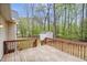 View of the backyard wooden deck and shed, surrounded by lush trees at 340 Castleberry Rd, Clayton, NC 27527