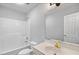 Well-lit bathroom with a shower-tub combo, toilet, vanity and mirror at 340 Castleberry Rd, Clayton, NC 27527