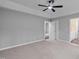 Spacious bedroom features a tray ceiling, ceiling fan, and access to the bathroom at 340 Castleberry Rd, Clayton, NC 27527