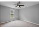 Comfortable bedroom featuring a window, carpeted floor, and neutral gray walls at 340 Castleberry Rd, Clayton, NC 27527
