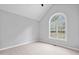 Sun-filled bedroom with neutral carpet, large window, and vaulted ceiling at 340 Castleberry Rd, Clayton, NC 27527