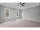Light and airy bedroom with tray ceilings, ceiling fan, and two large windows at 340 Castleberry Rd, Clayton, NC 27527