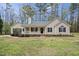 Charming single-story home with a welcoming front porch, complemented by a well-maintained yard and mature trees at 340 Castleberry Rd, Clayton, NC 27527