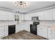 Updated kitchen featuring white cabinets, light countertops and new appliances at 340 Castleberry Rd, Clayton, NC 27527