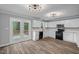 Modern kitchen with white cabinets, stainless steel appliances, and access to an outdoor deck at 340 Castleberry Rd, Clayton, NC 27527