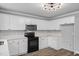 Eat-in kitchen with modern black appliances, white cabinets, and light countertop at 340 Castleberry Rd, Clayton, NC 27527