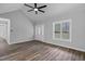Spacious living room with wood-look flooring, a large window, and an inviting front door at 340 Castleberry Rd, Clayton, NC 27527