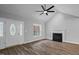 Cozy living room with wood-look floors, a fireplace, and a decorative front door, perfect for entertaining at 340 Castleberry Rd, Clayton, NC 27527