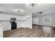 Bright open living space with kitchen, door, and window views and modern ceiling fans and light fixtures at 340 Castleberry Rd, Clayton, NC 27527