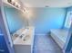A primary bathroom with double sinks, large mirror, tub, and tile floors at 357 Riverwood Dr, Clayton, NC 27527