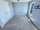 Carpeted bedroom with natural light from the window, a closet, and a modern ceiling fan at 357 Riverwood Dr, Clayton, NC 27527